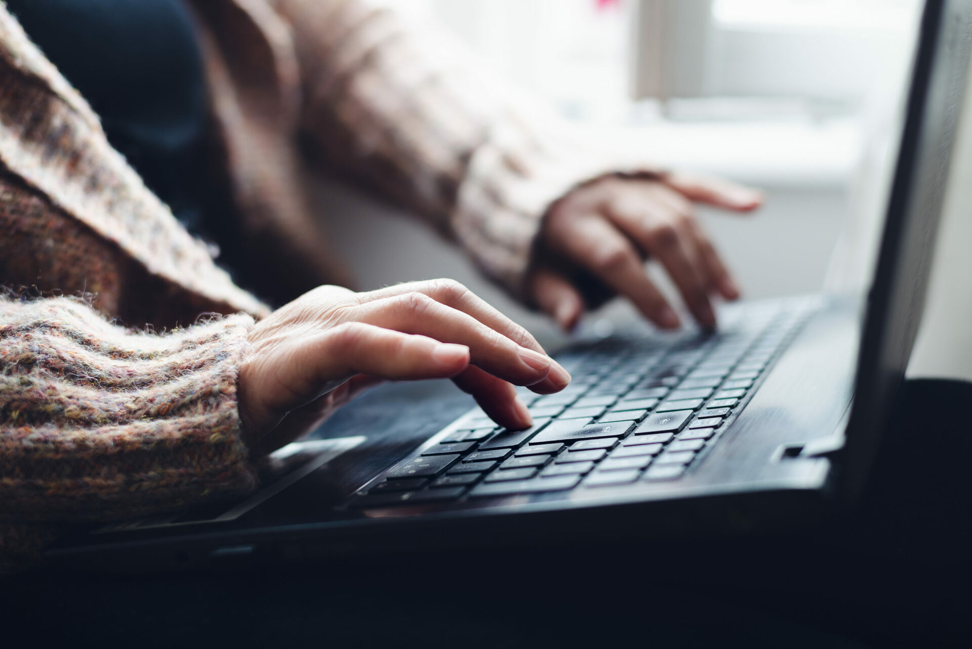 a woman typing on her keyboard to respond to a creative writing prompt