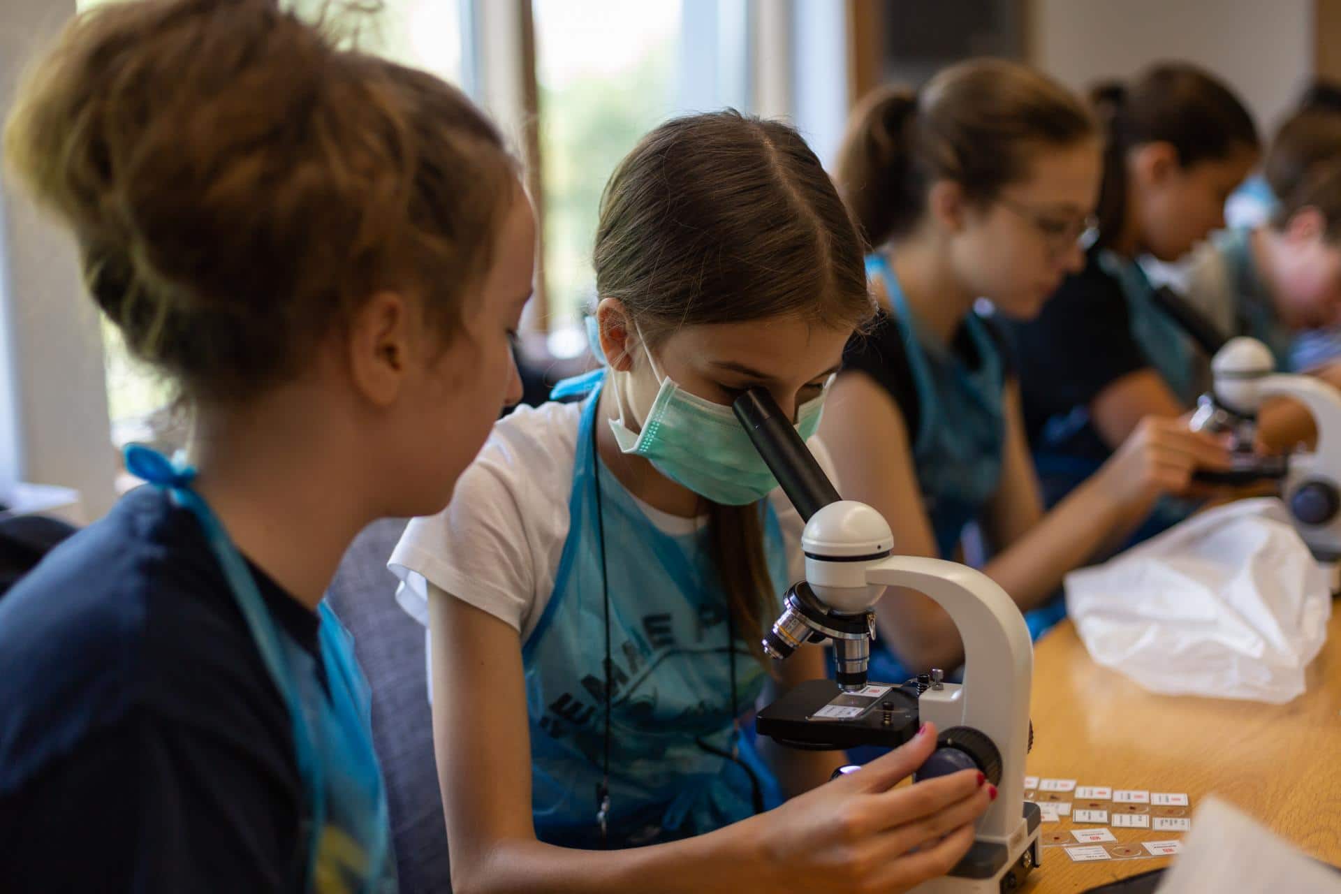Students using a microscope in their laboratory.