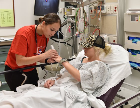 female doctor checking patients hand in hospital