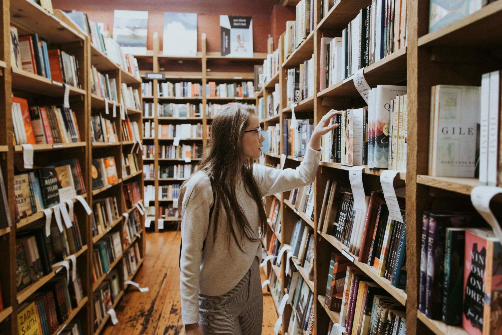 a girl choosing a book in the library