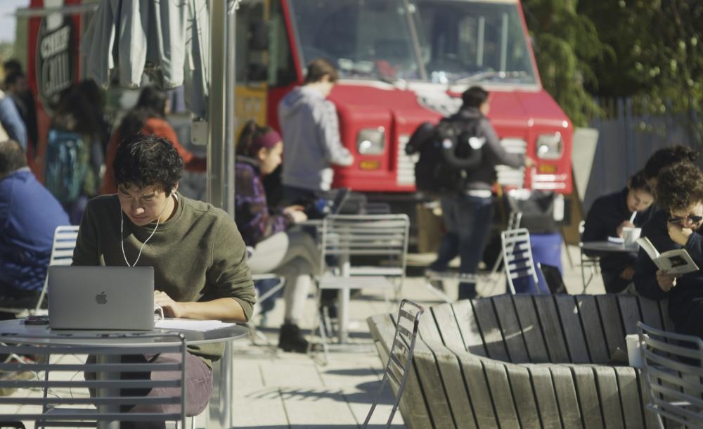 a man sitting at a table with a laptop