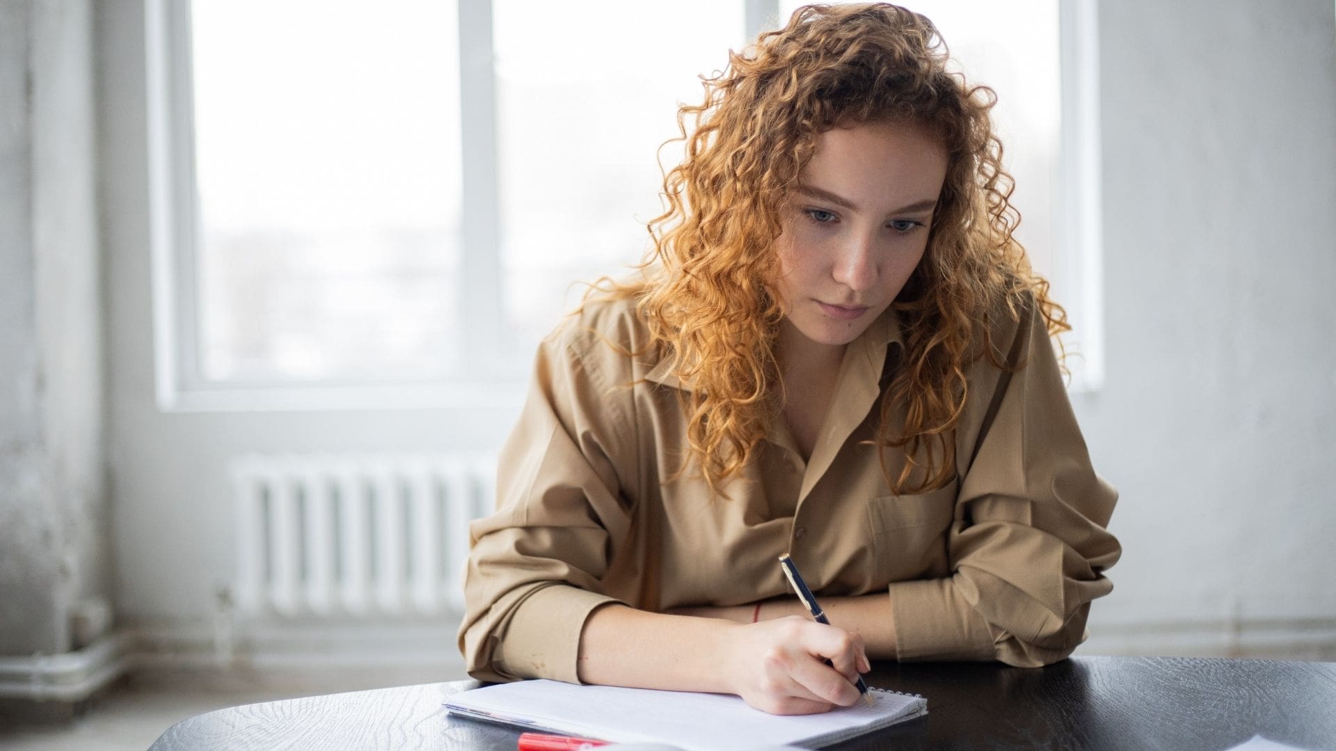 Woman writing on her notebook