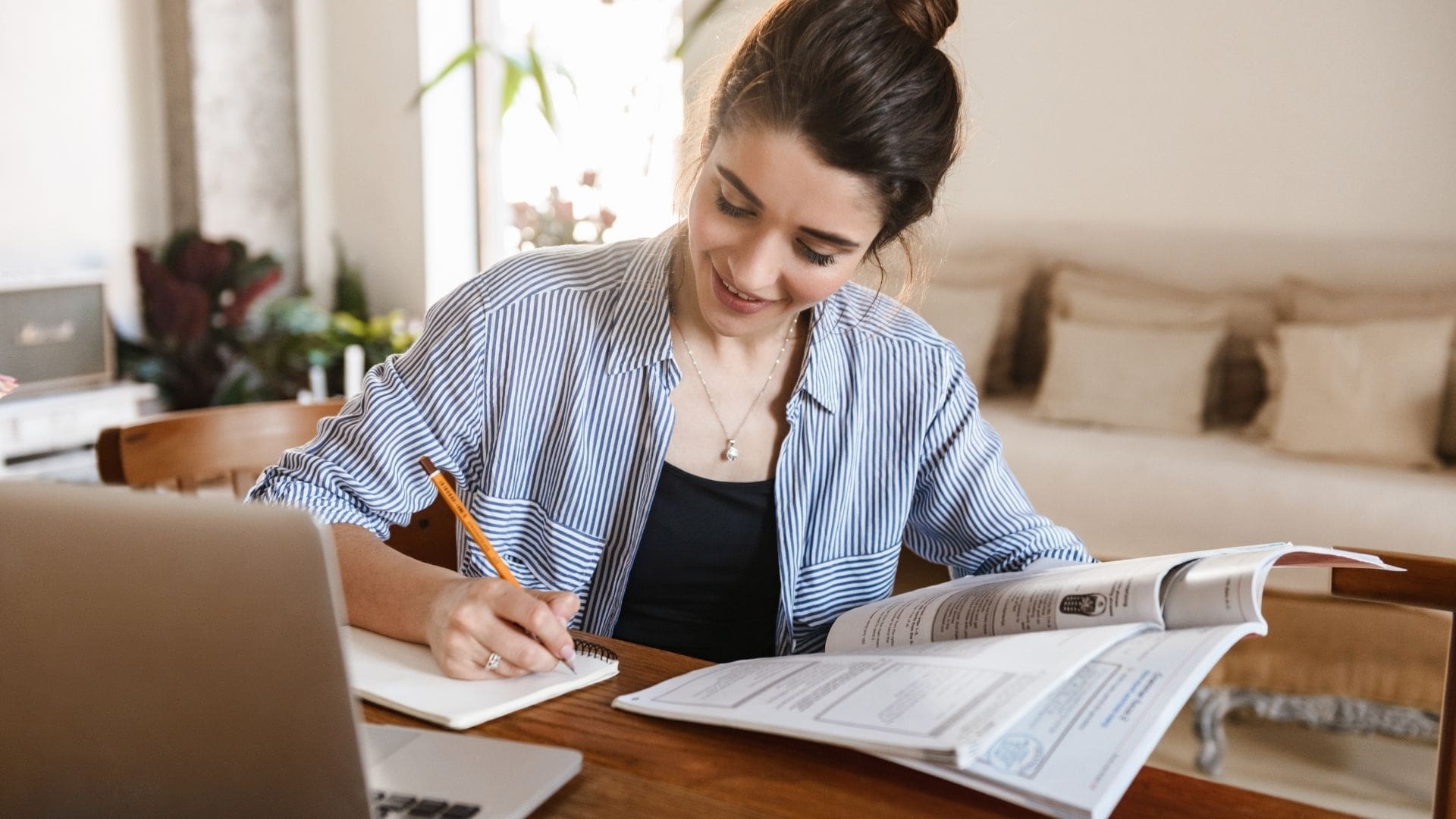 A woman taking notes on the book she was reading.