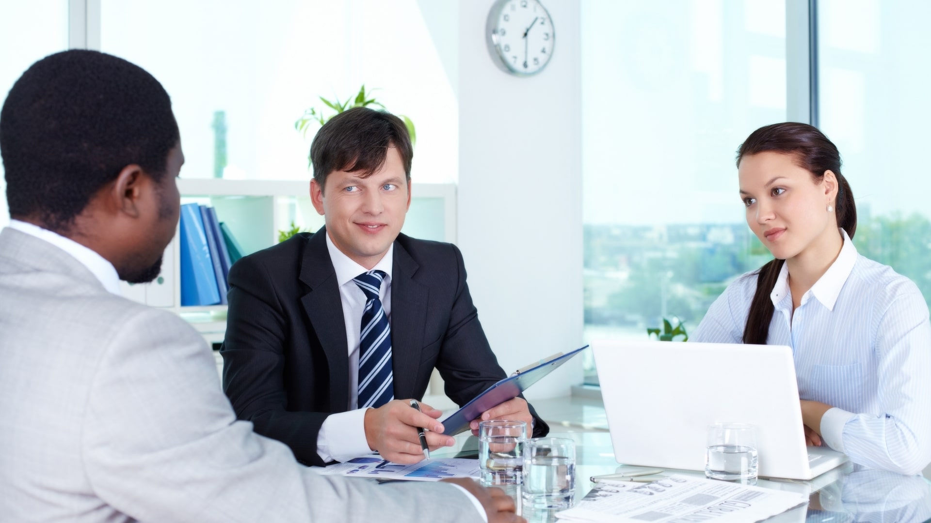 A man interviewed by two people.