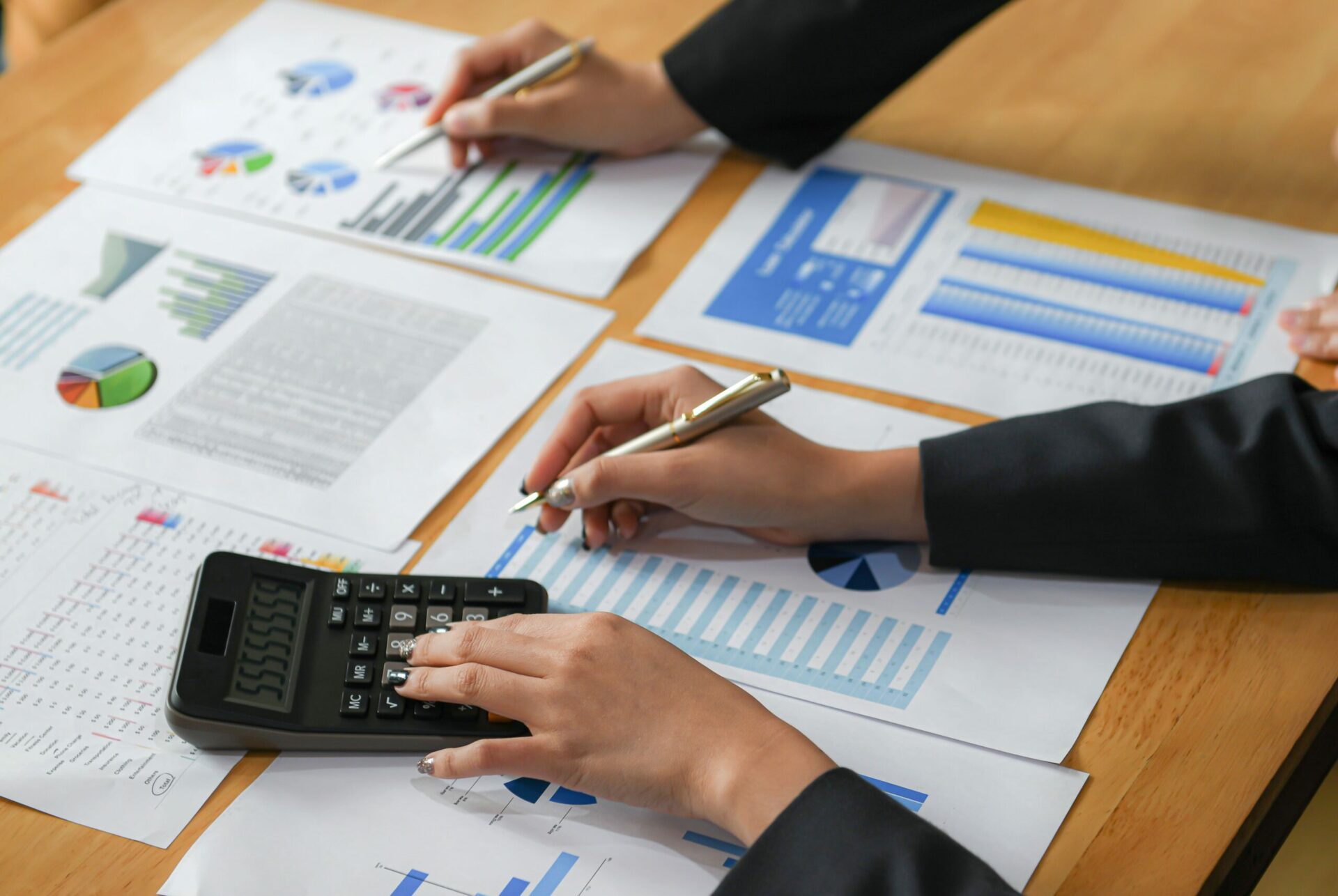 accountant with calculator and documents on desk