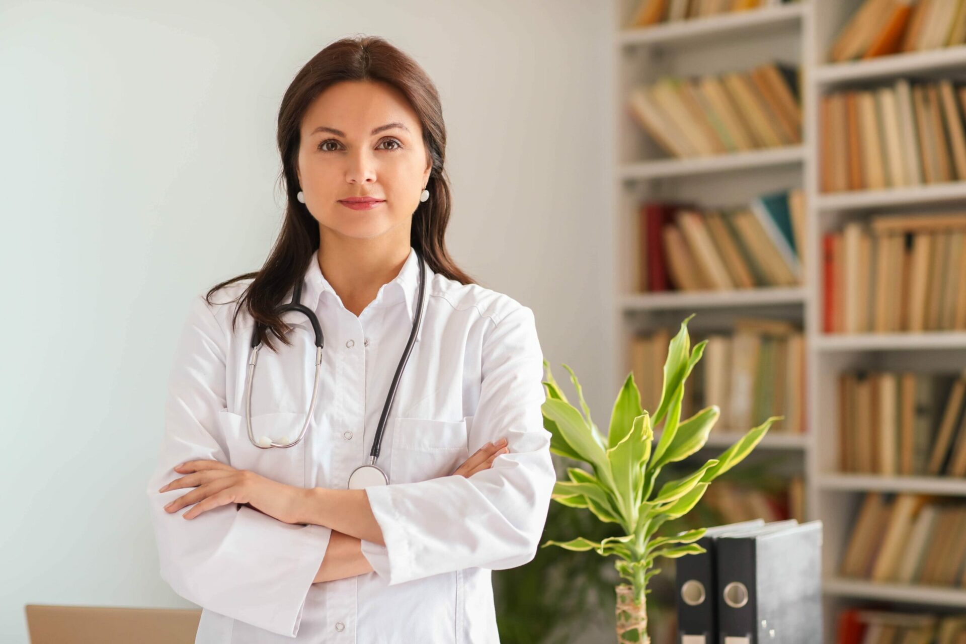 Female doctor in white fronting camera