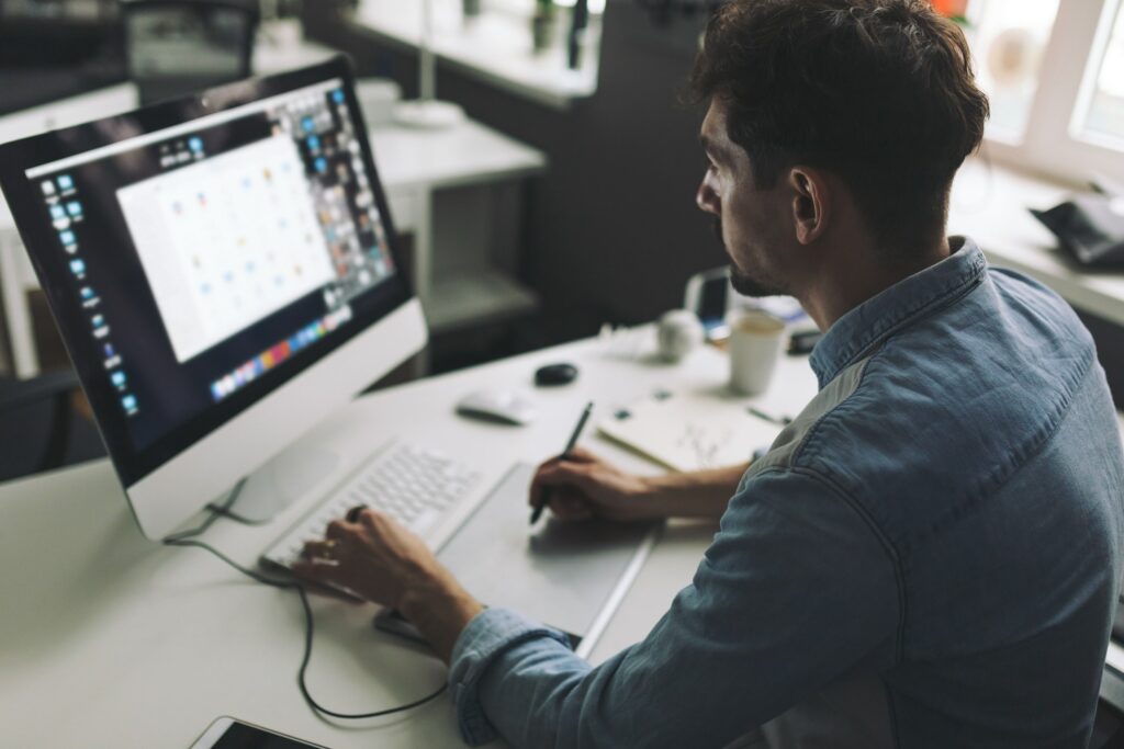 Male graphic designer in front monitor