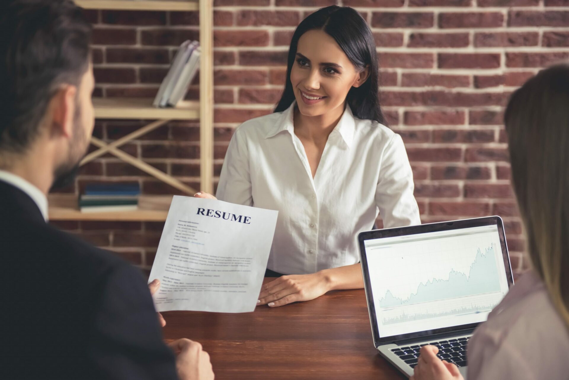 Woman presenting resume to interviewer