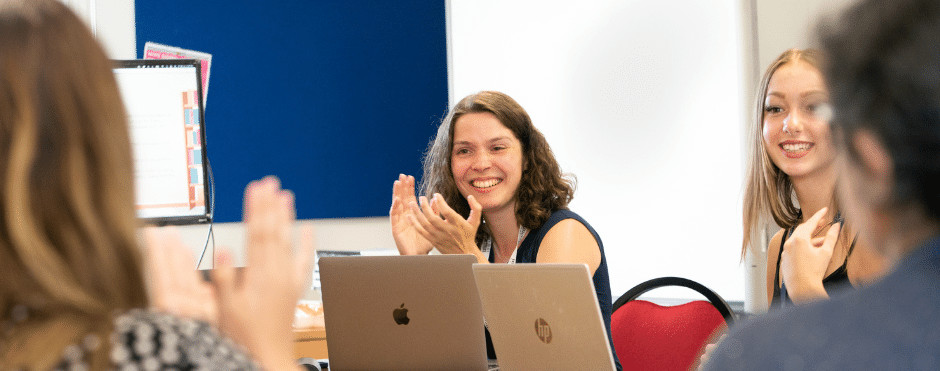 A woman clapping happily.