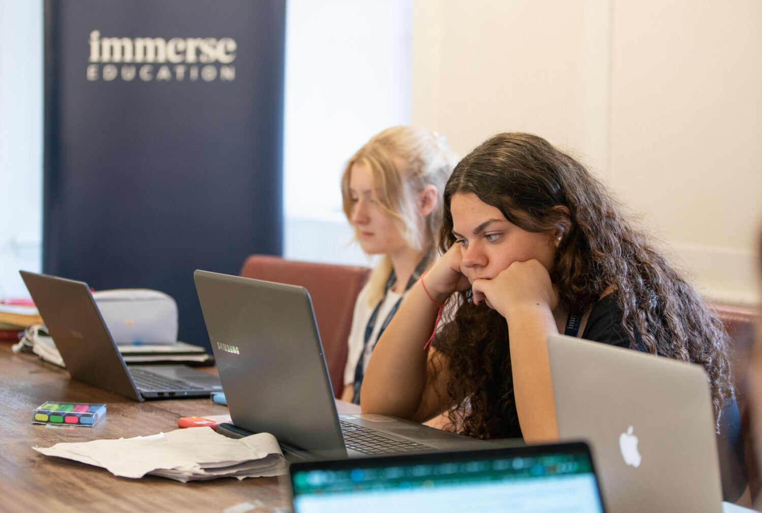 A woman looking intently to her laptop