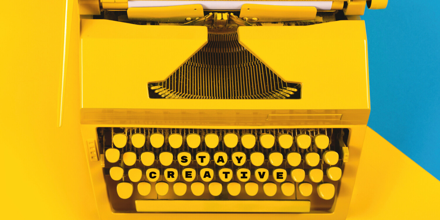 A yellow typewriter that emphasizes 'Stay Creative'.