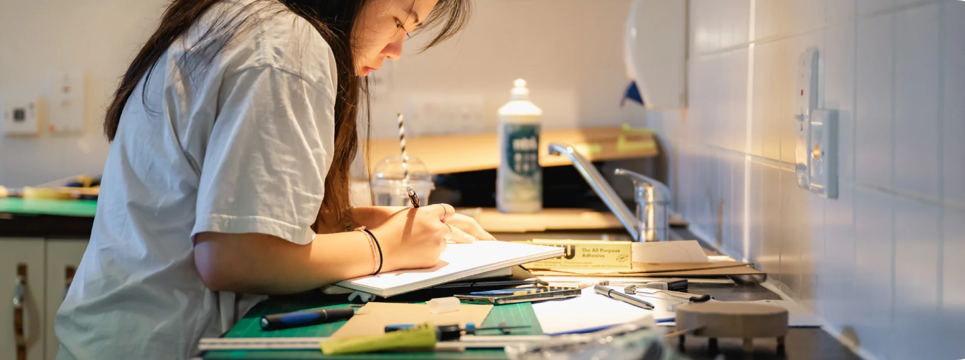 A woman writing something on a notebook.