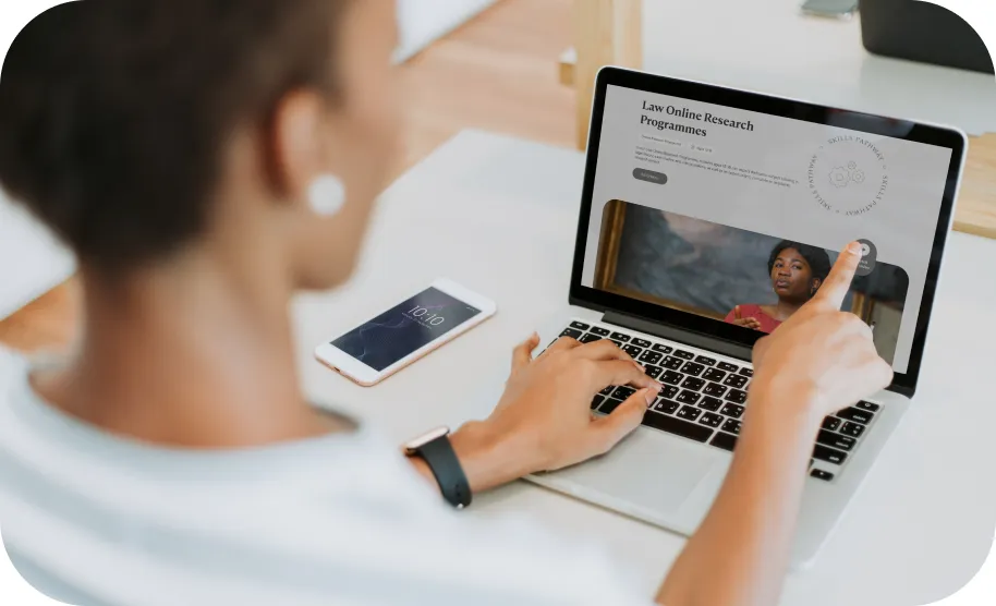 A woman pointing at her laptop.