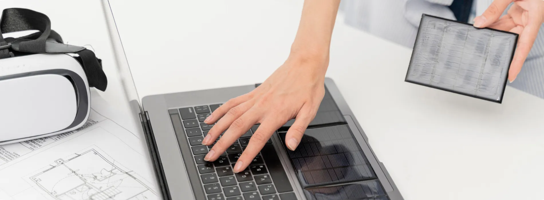 A hand typing on a keyboard