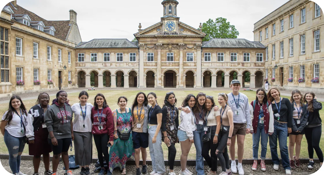 a group of students posing for a photo in front of a school