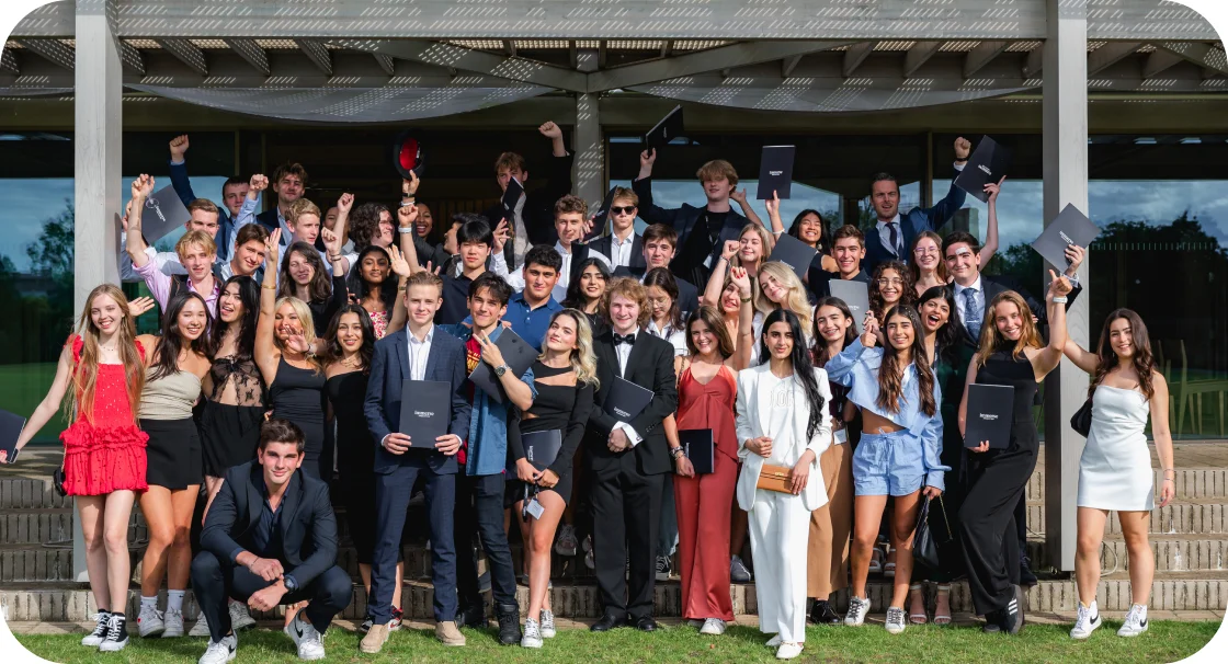 a group of students posing holding a diploma