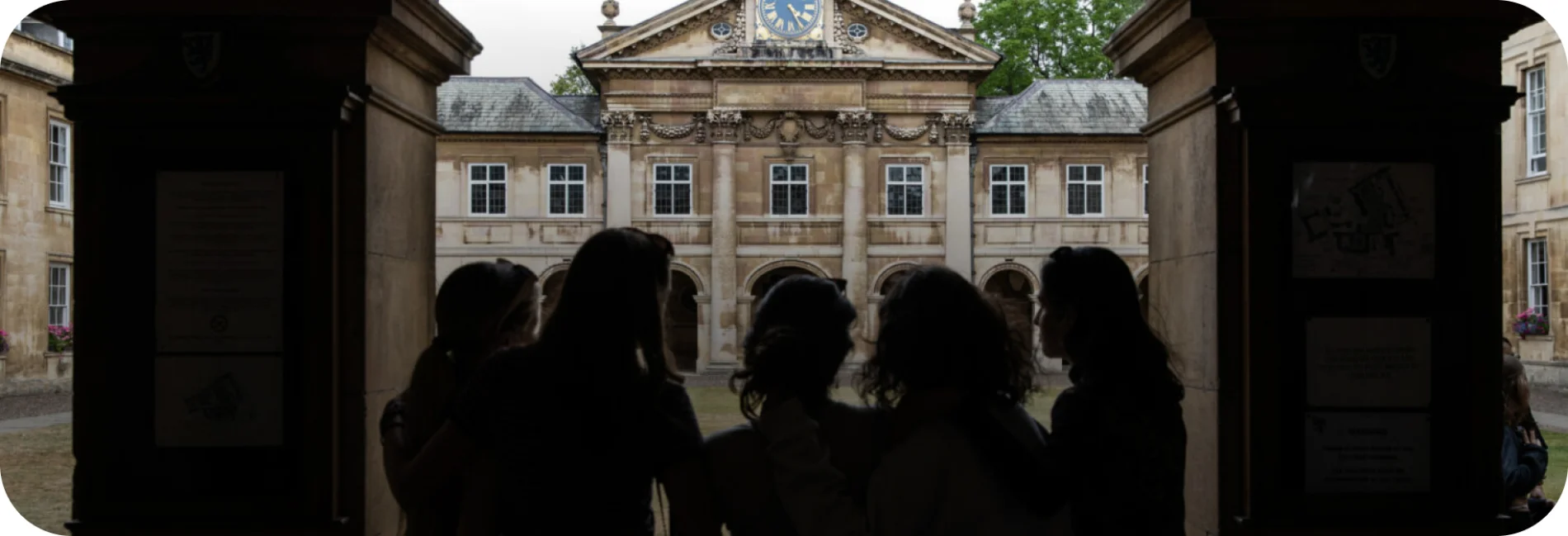 a group of students standing in front of a school