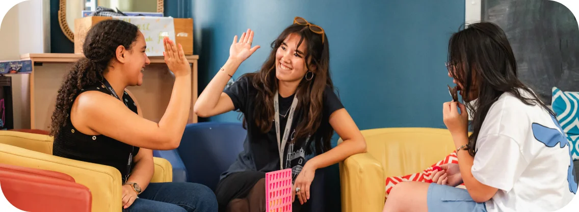 Two women doing a high five