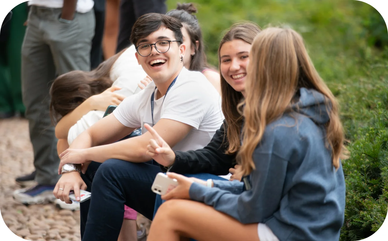 Group of people laughing and talking outside.