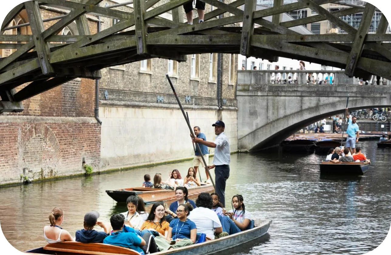 a group of people in a boat under a bridge