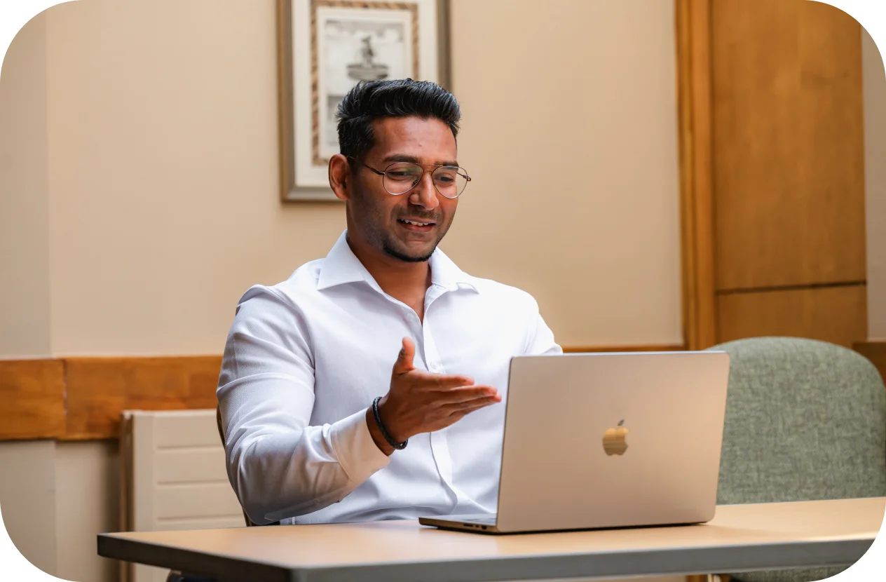 A man talking in front of the laptop