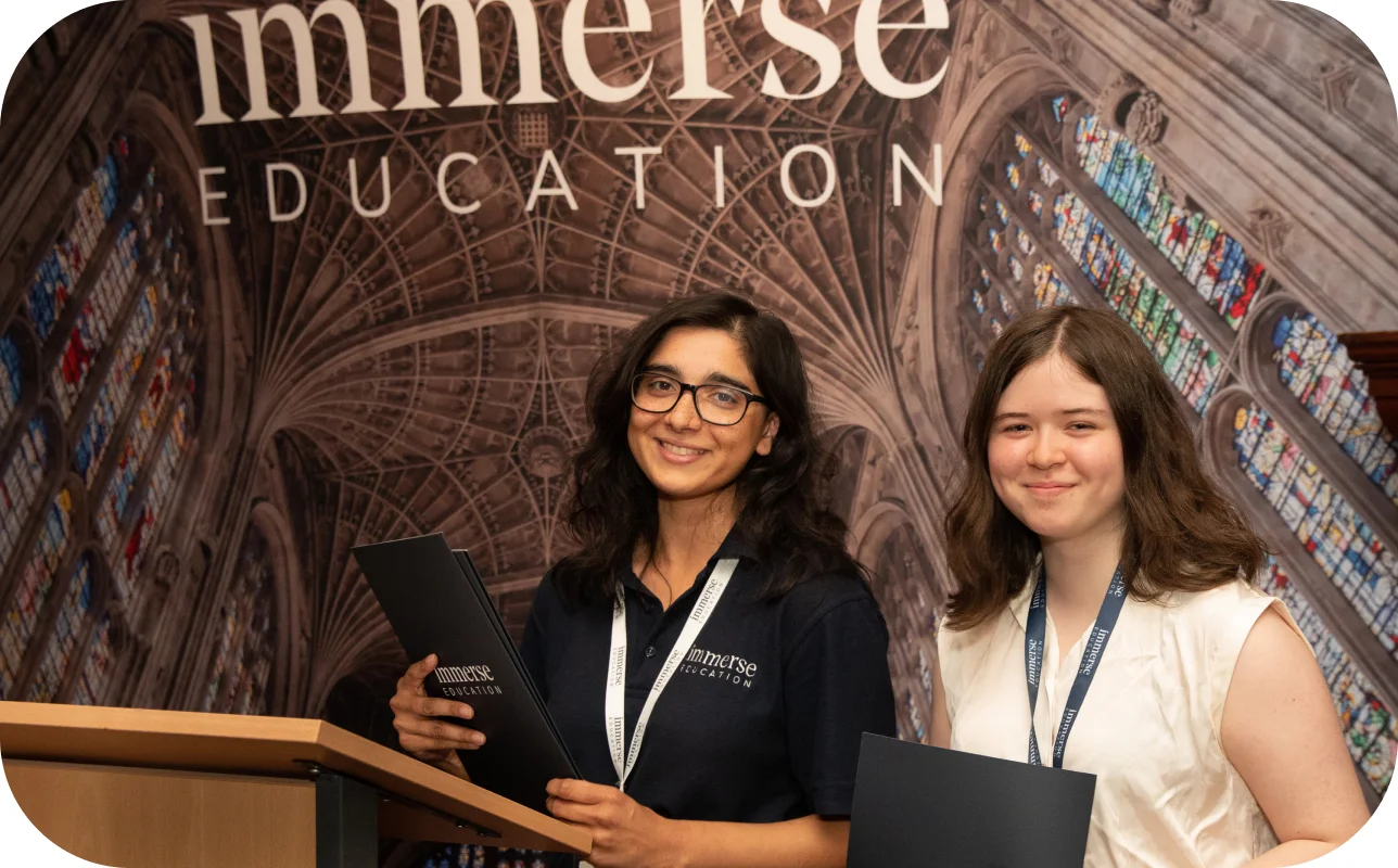 Two women holding diplomas