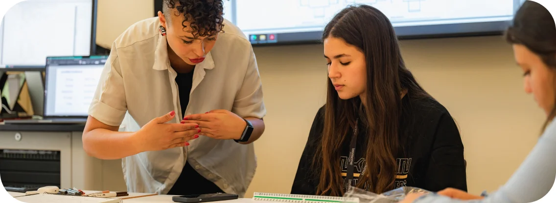 Hands-on teacher explaining thoroughly to a student.