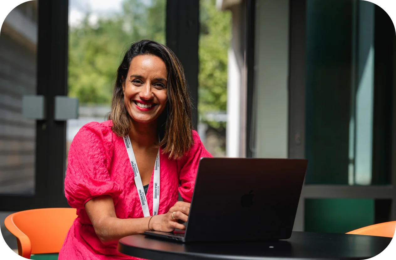 a woman smiling with a laptop