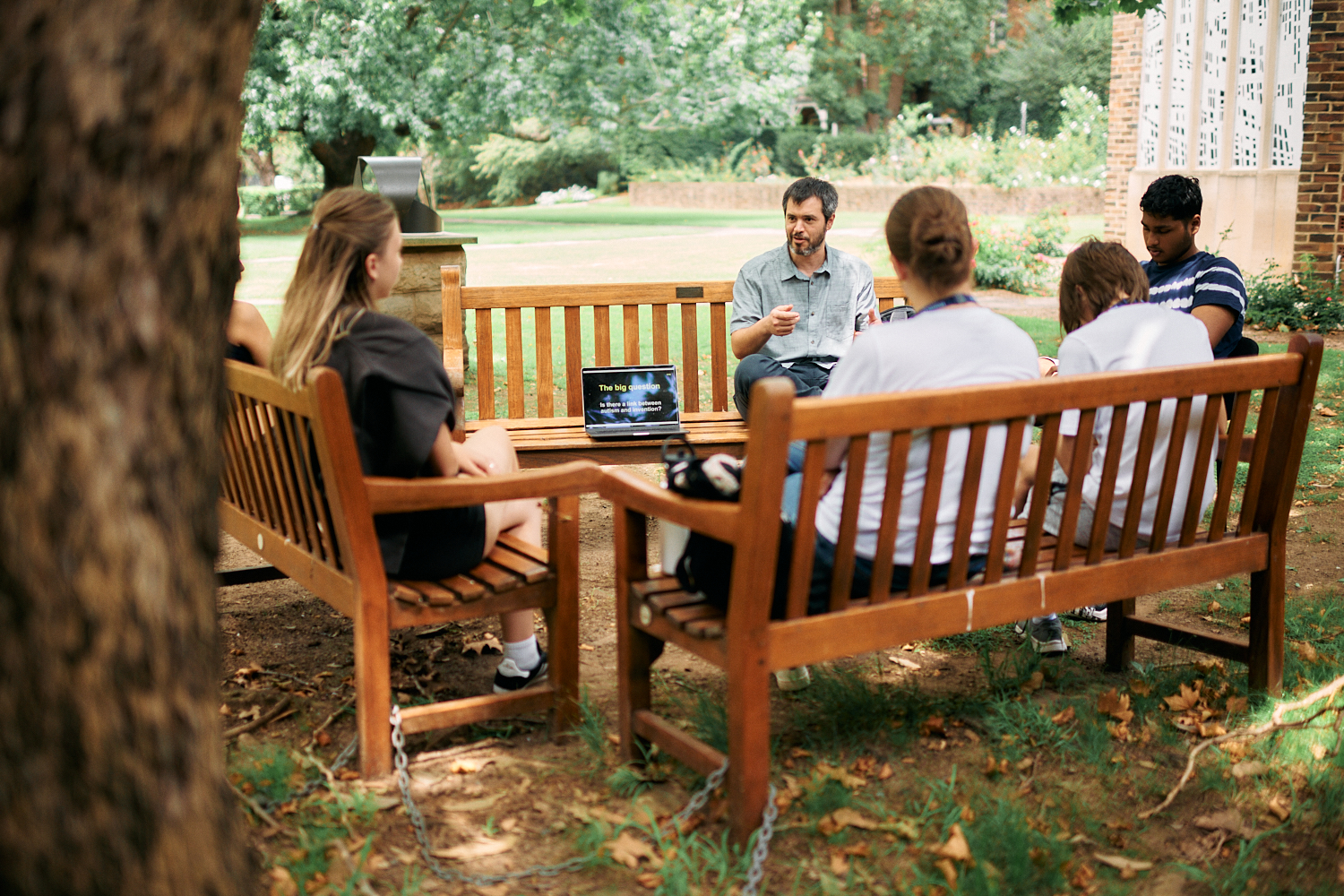 a man presenting to a group of people outdoor