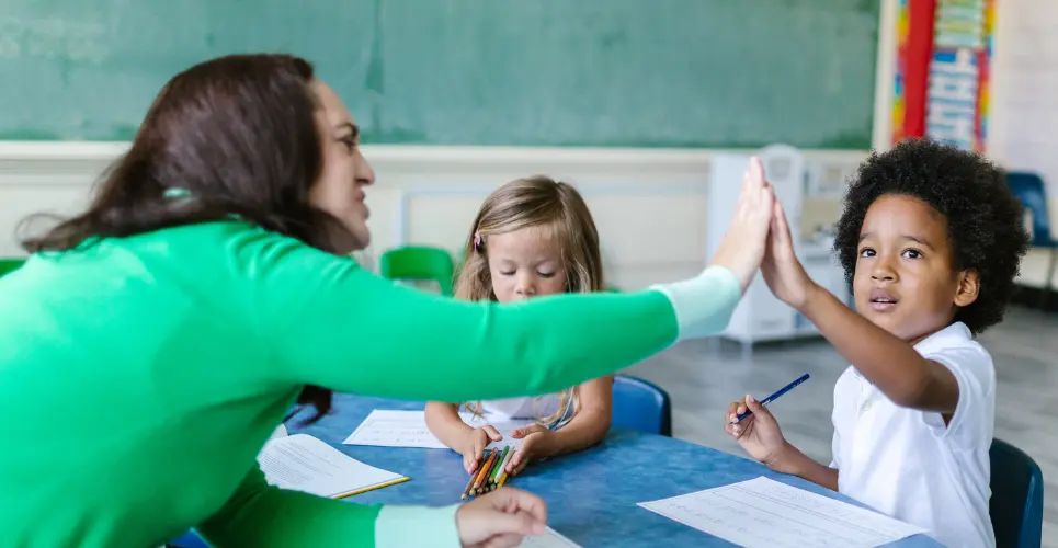 Teacher and child students at school