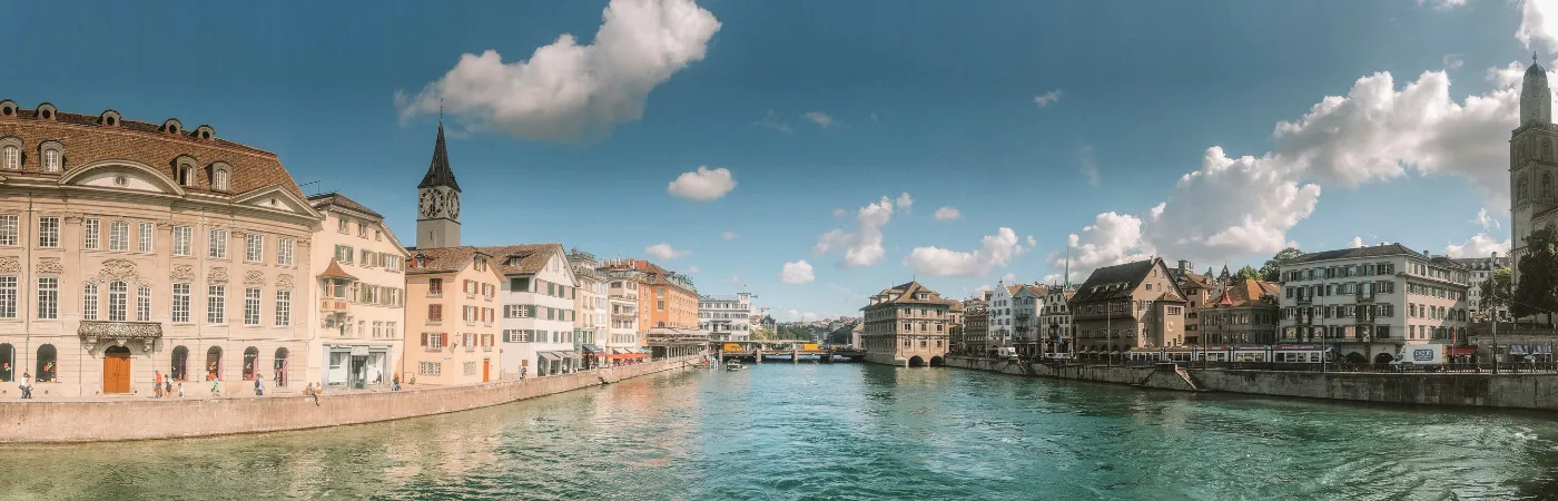 Captivating Swiss landscape with mountains, lakes, and green fields.
