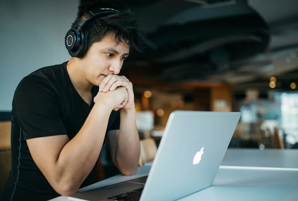 Student wearing headphones while on laptop