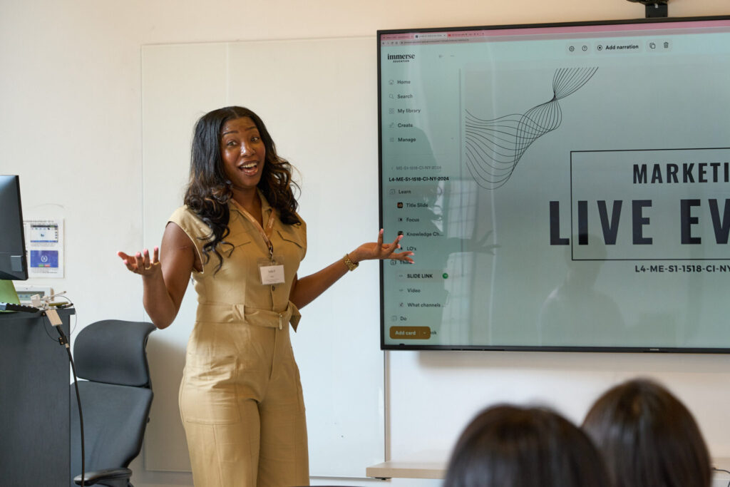A year 12 student in a brown jumpsuit pitching her business with a slide deck as part of a work experience activity