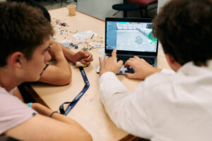 STEM students completing an engineering project on a laptop during their summer school