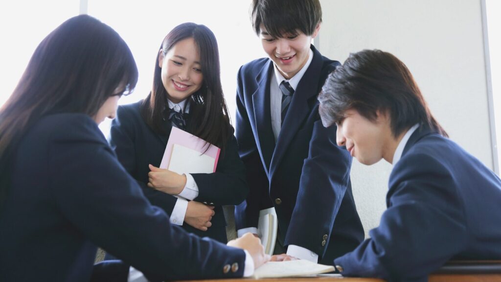 Four business students together studying up on how to get into the university of South Wales