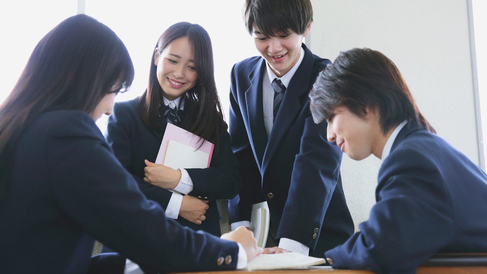 Four business students together studying up on how to get into the university of South Wales