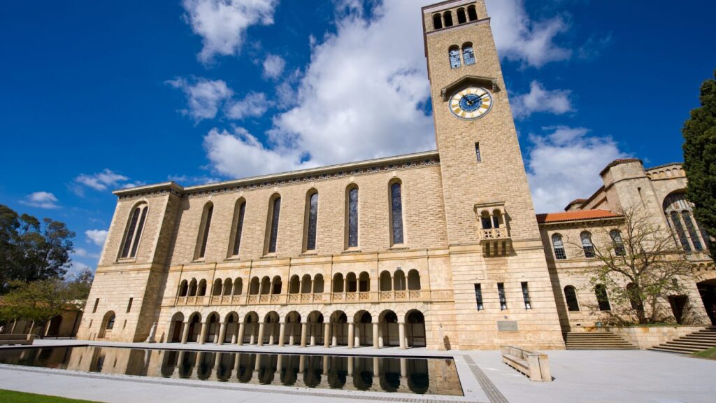 An image of the exterior of the University of Western Australia, a large sandstone building with Romanesque-style architecture