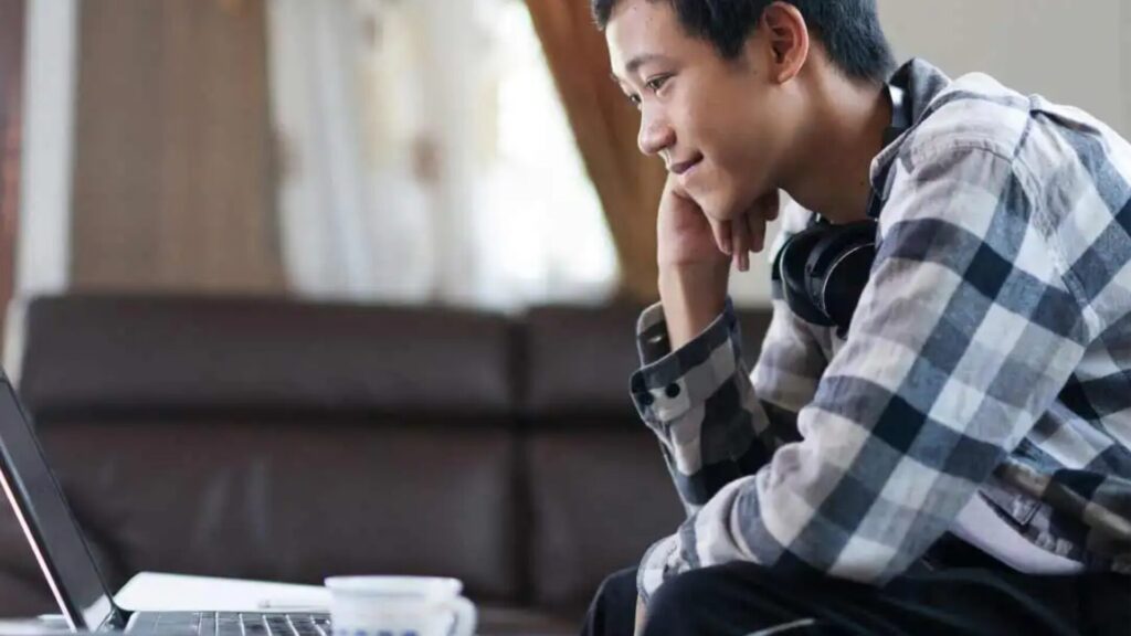 A student attending an online using their laptop