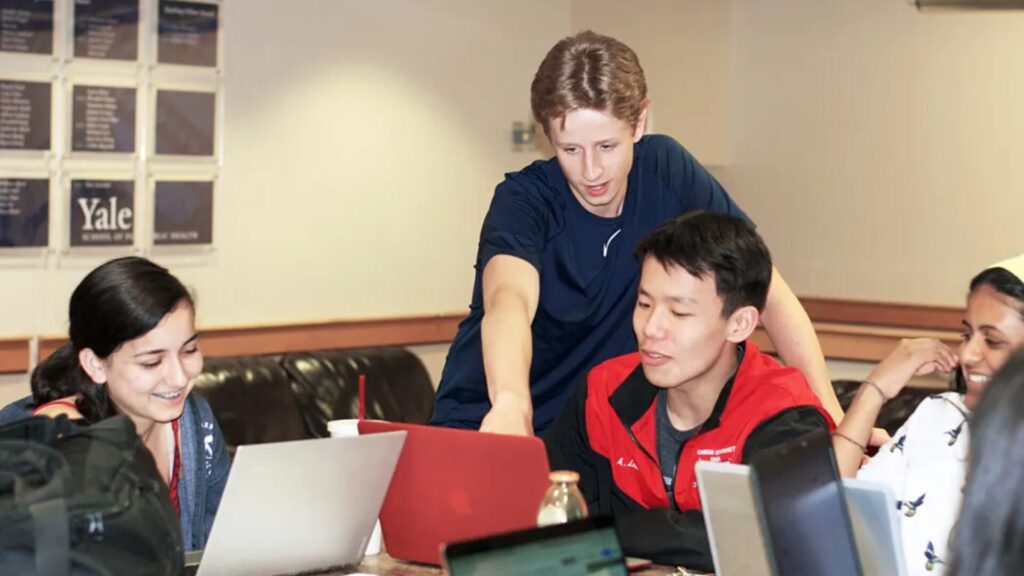Peer mentors and students work on a research project.