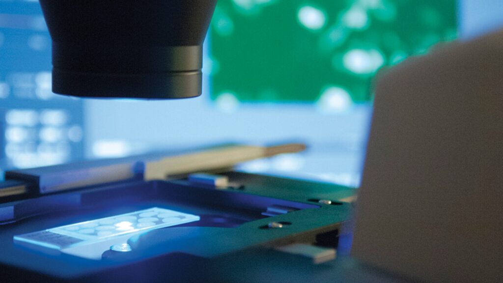 A zoomed-in shot of a device analysing a slide that has been placed under it