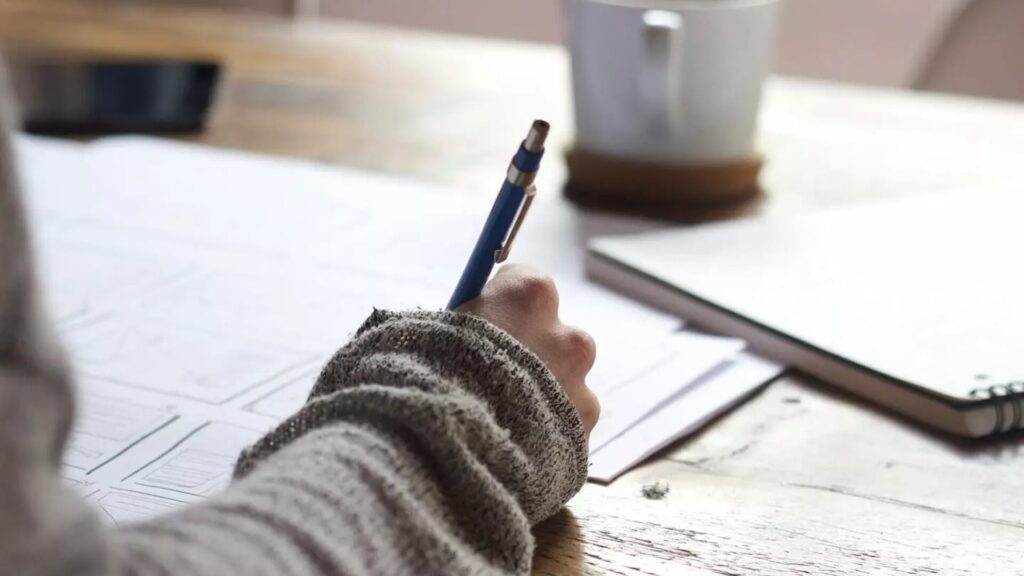 A student writing on a piece of paper