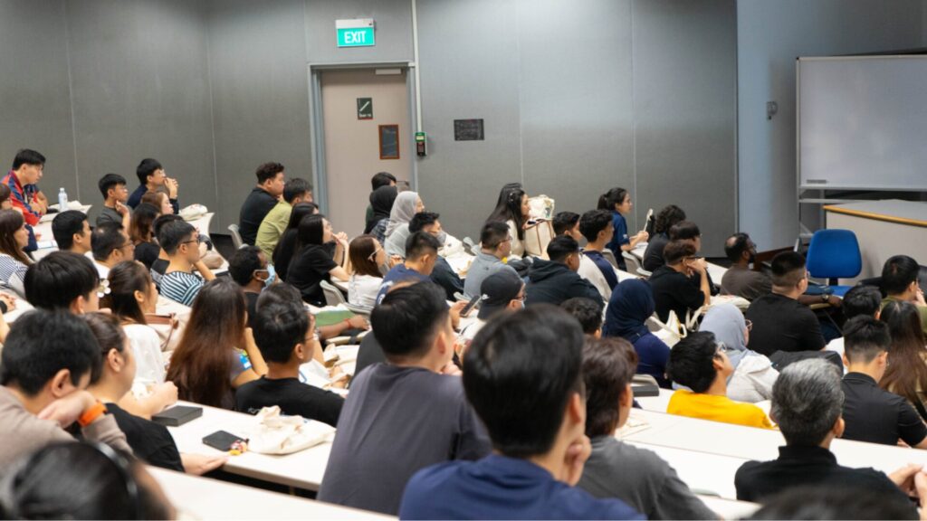 A group of students sitting in an elevated classroom