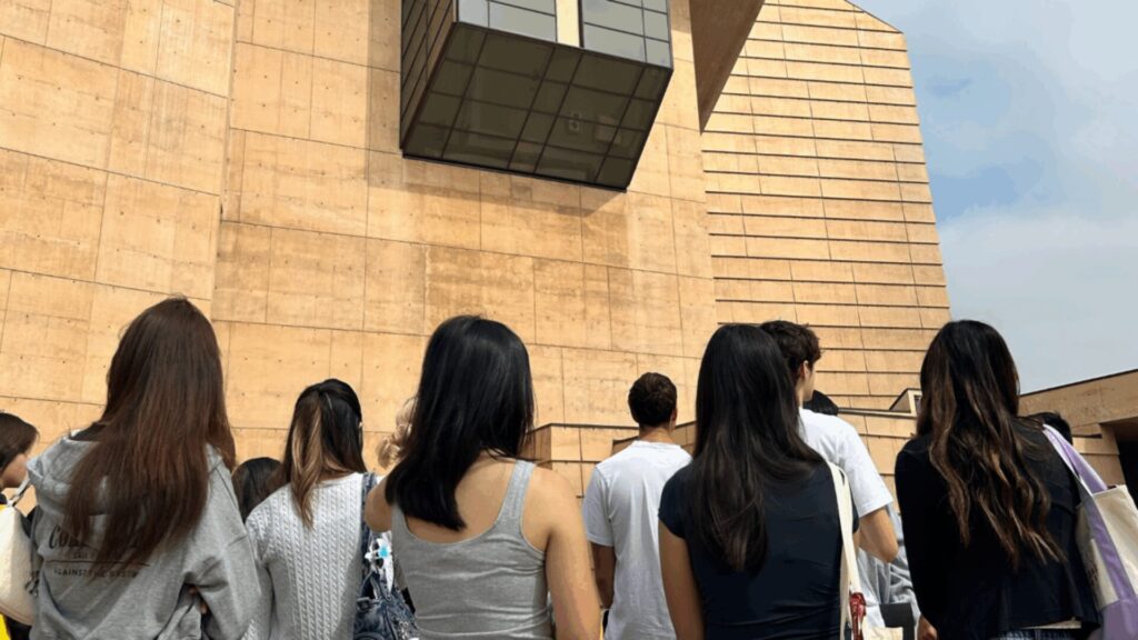 Students studying an architectural structure in LA while part of an architectural walking tour