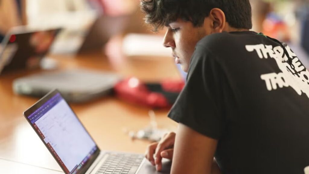 A student attending an online using their laptop